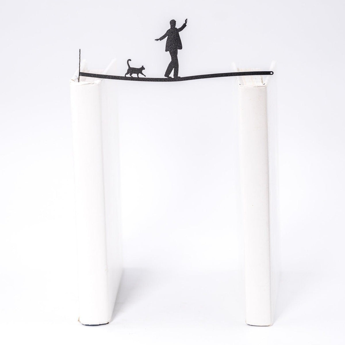 Balancing Act metal bookmark shown flat on a white background