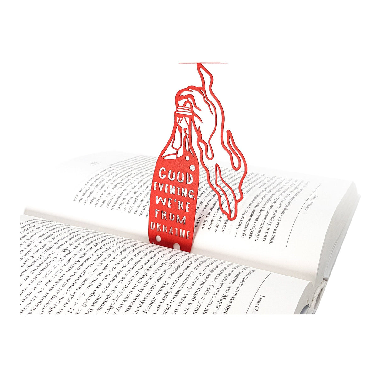 Bandera Smoothie metal bookmark in red resting on the pages of an open book