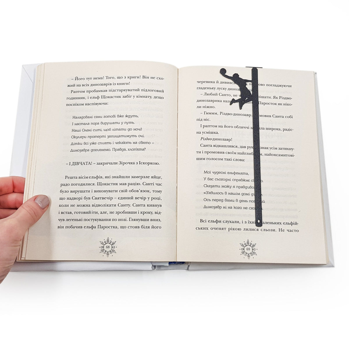 Basketball metal bookmark held up beside an open book