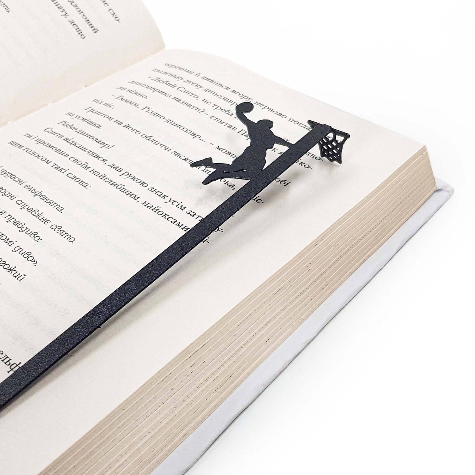 Basketball metal bookmark marking a page in an open book