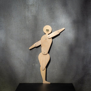 Back of Bauhaus circle dancer puppet in natural plywood showing brass wall hook and jointed construction