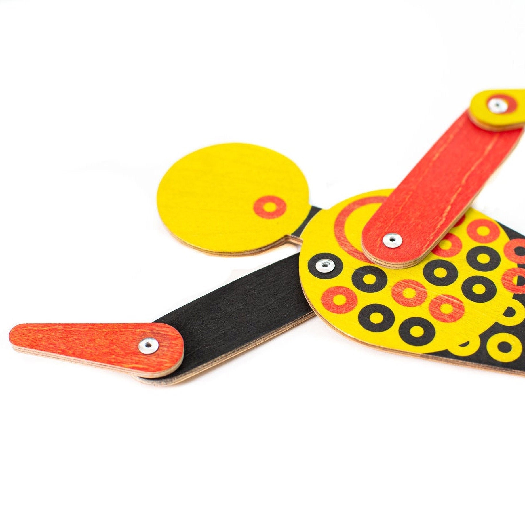 Close-up of Bauhaus circle dancer puppet showing plywood layers and printed circle pattern