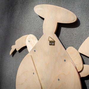 Back of Bauhaus harlequin puppet showing brass wall hook, plywood grain and metal joint fasteners