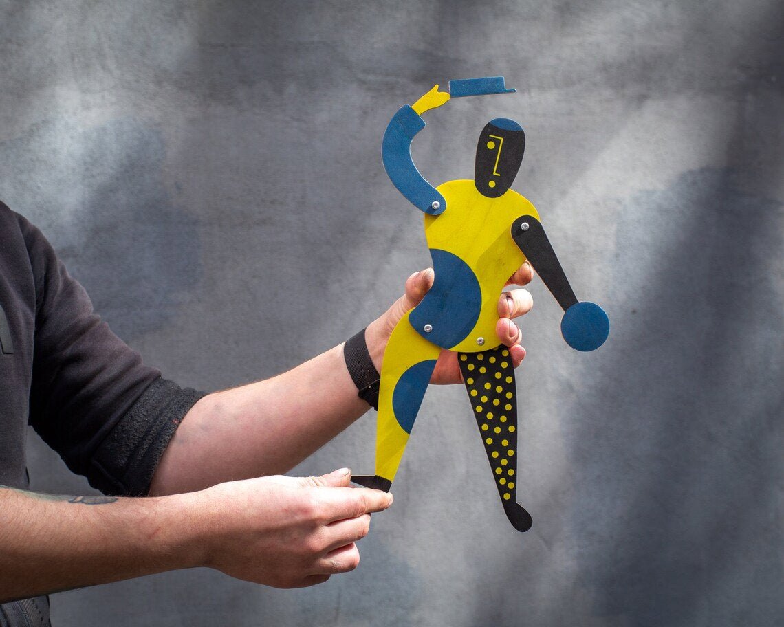 Bauhaus clown puppet held in both hands showing full proportions