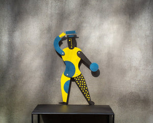 Bauhaus jumping jack puppet displayed standing on black shelf
