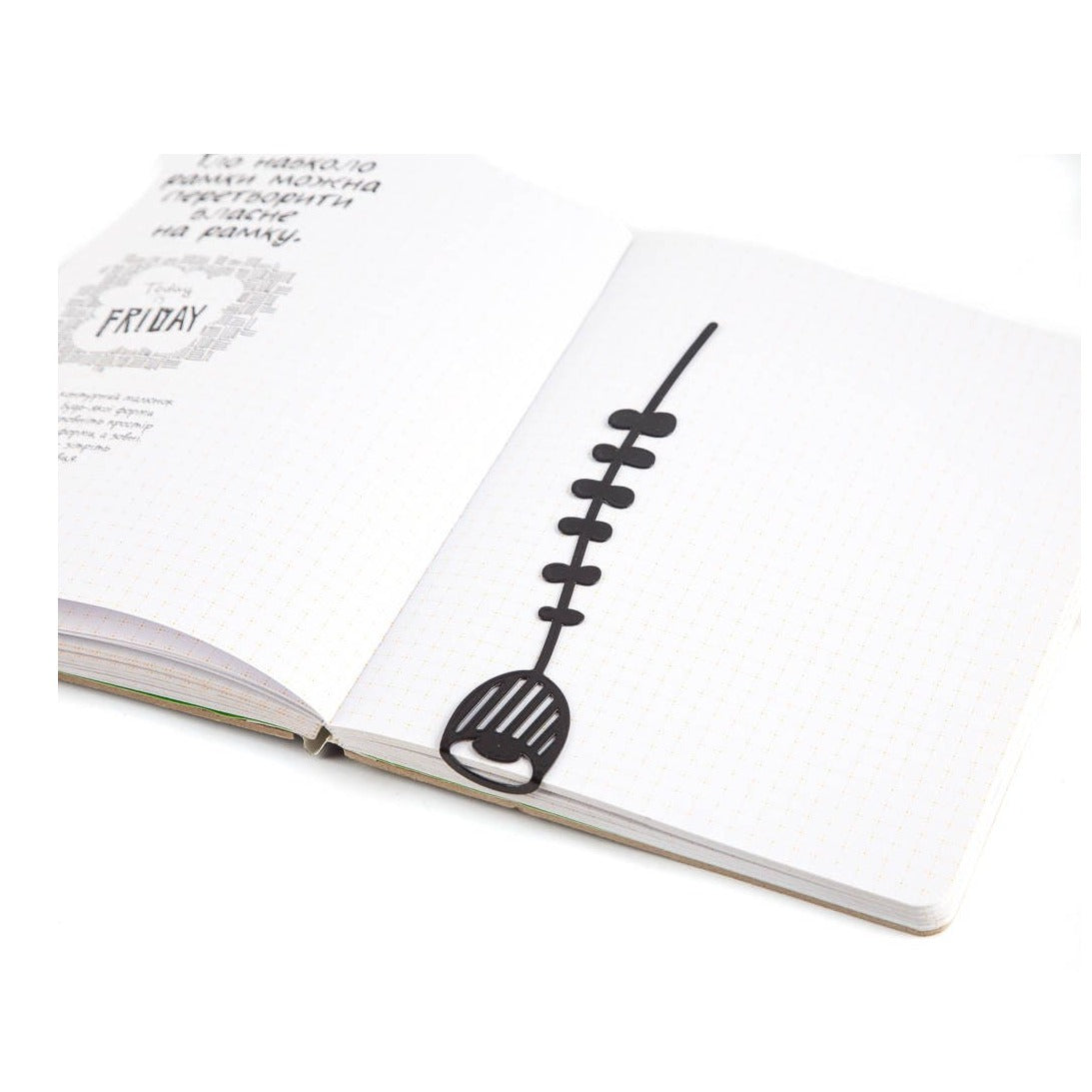 Bellflower metal bookmark resting on the pages of an open book