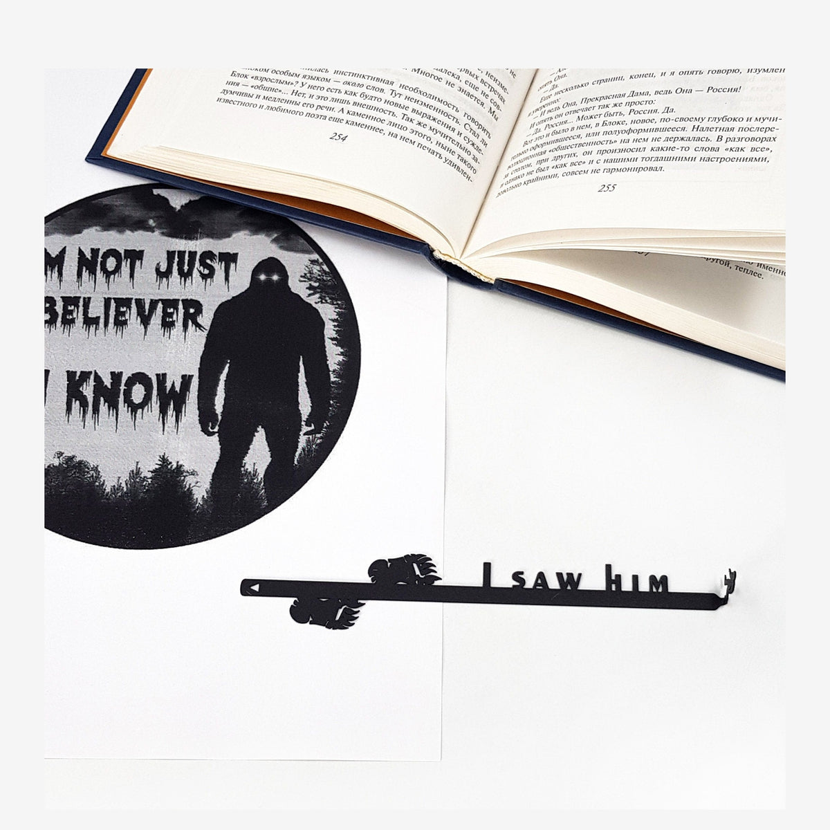 Bigfoot metal bookmark marking a page in an illustrated book