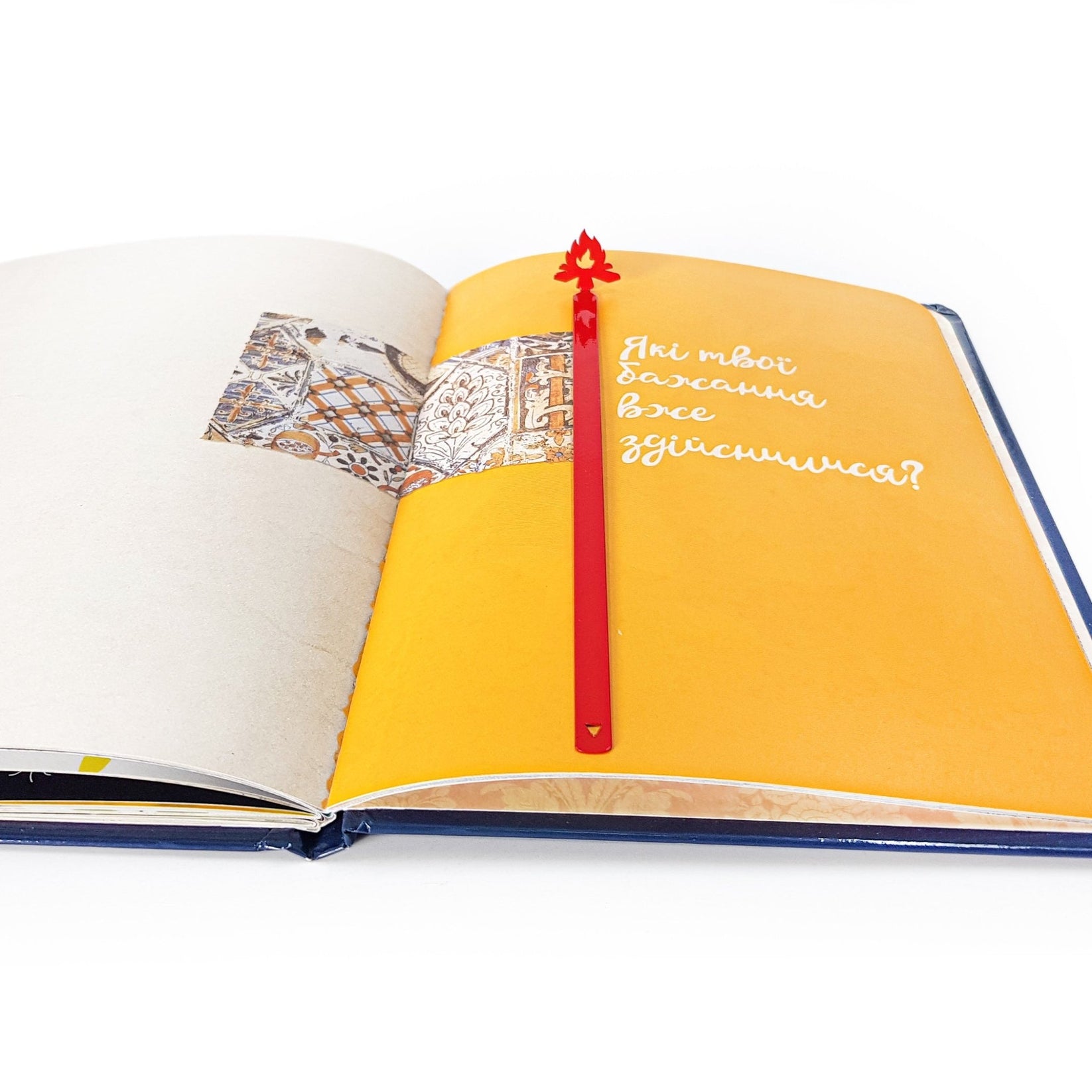 Bonfire metal bookmark in red resting on the pages of an open book
