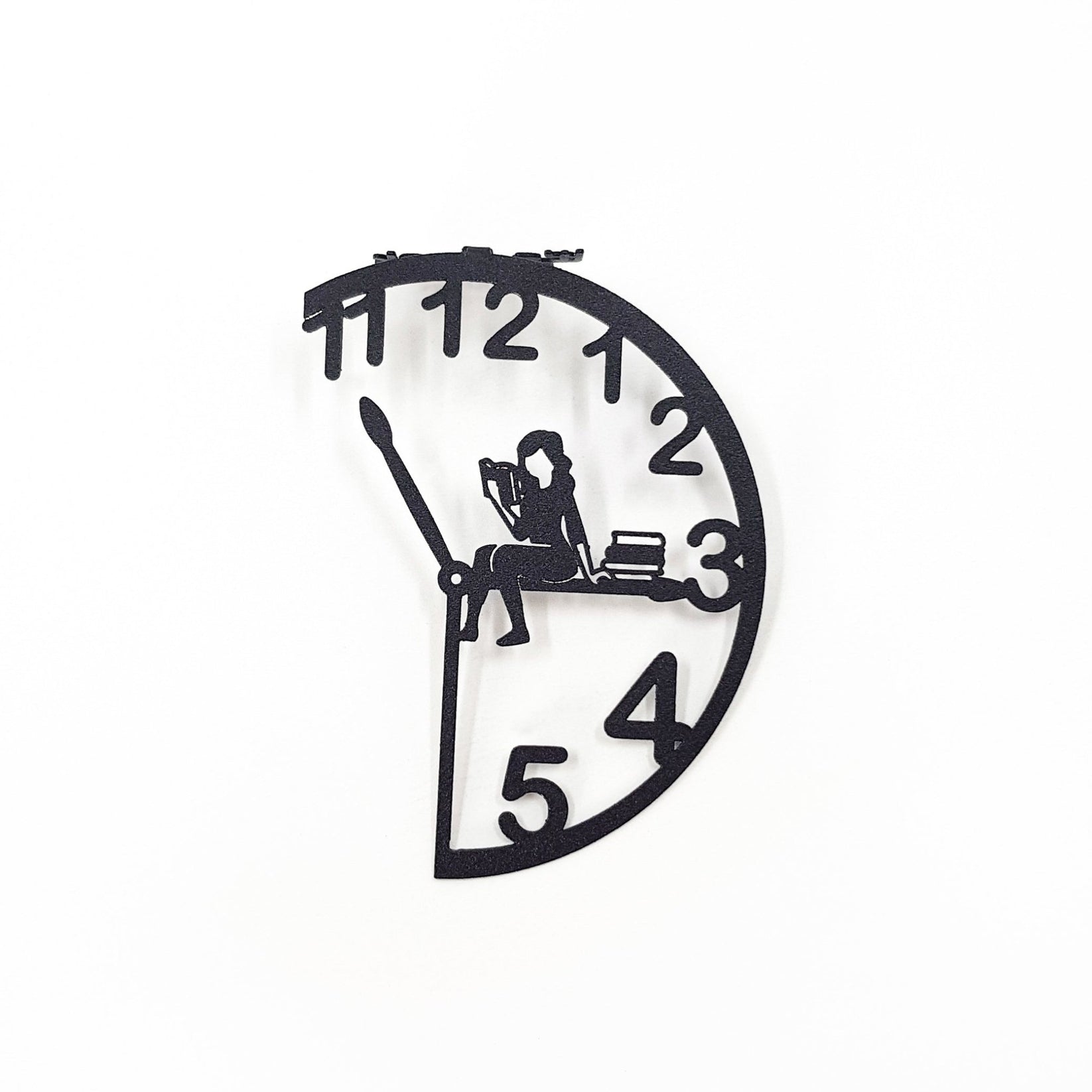 Black metal Book O’Clock bookmark with a clock-shaped design and a seated reading figure, shown isolated on a white background.