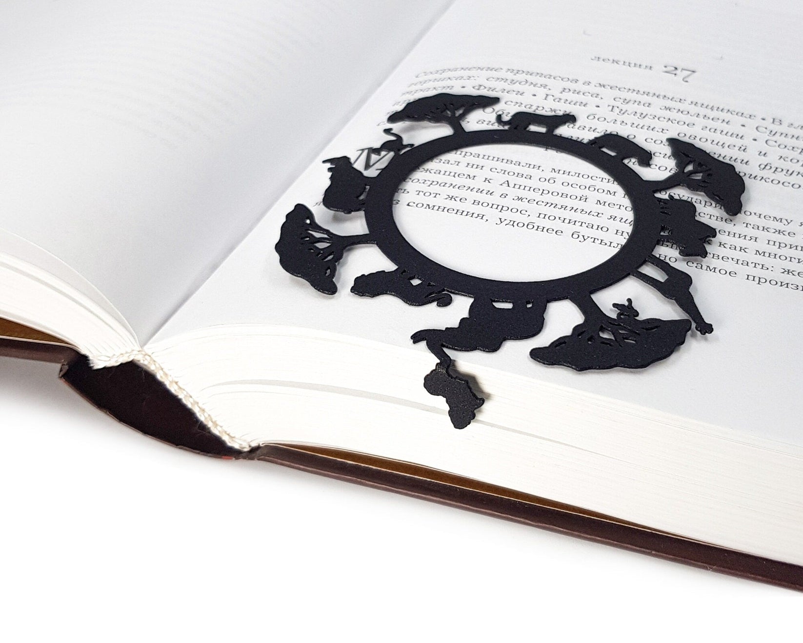 Africa Map metal bookmark set into the gutter of an open book