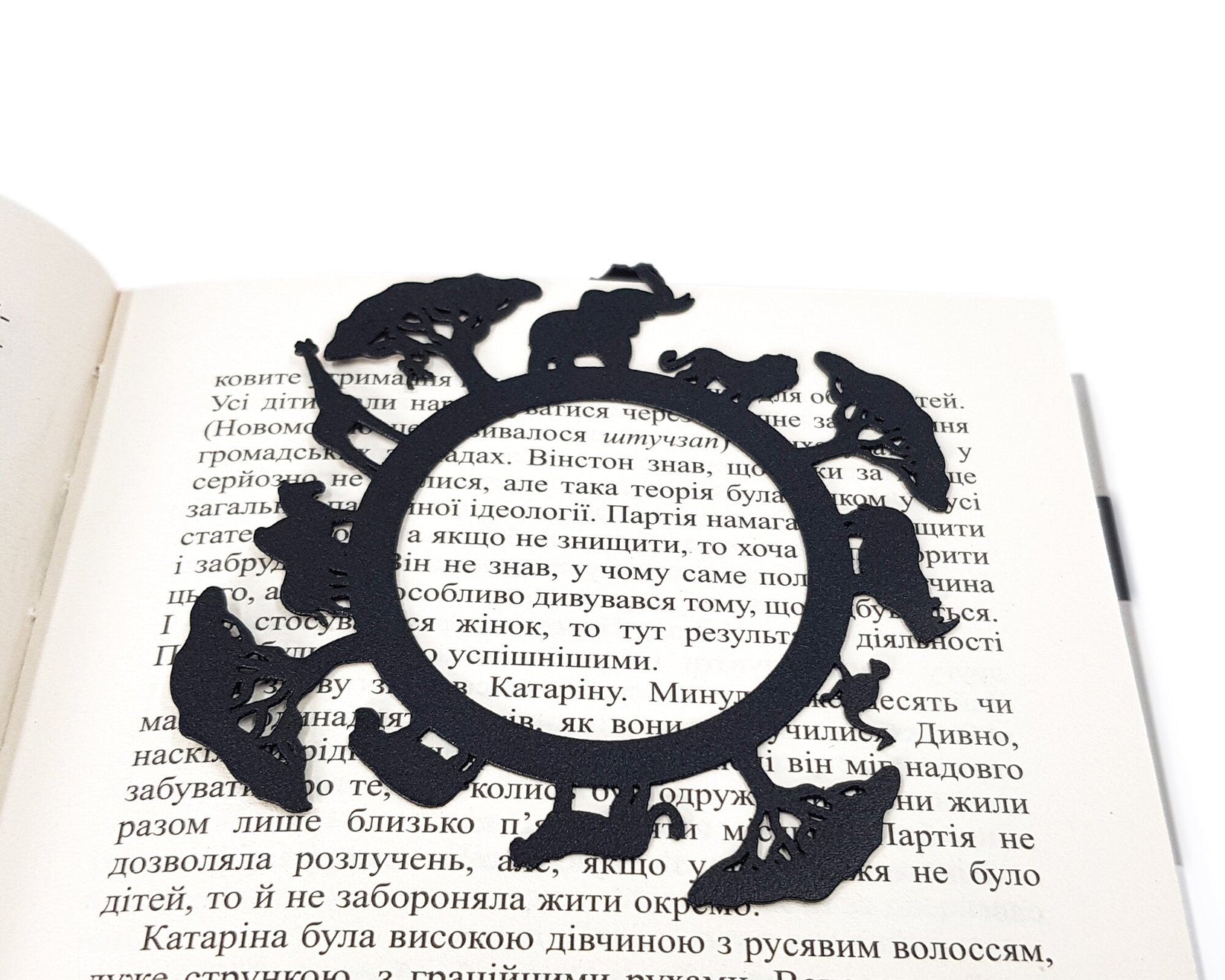 Africa Map metal bookmark lying across the pages of an open book