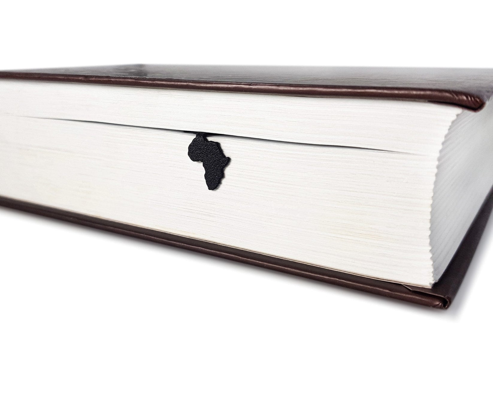 Africa Map metal bookmark in a closed book, only its top showing above the pages