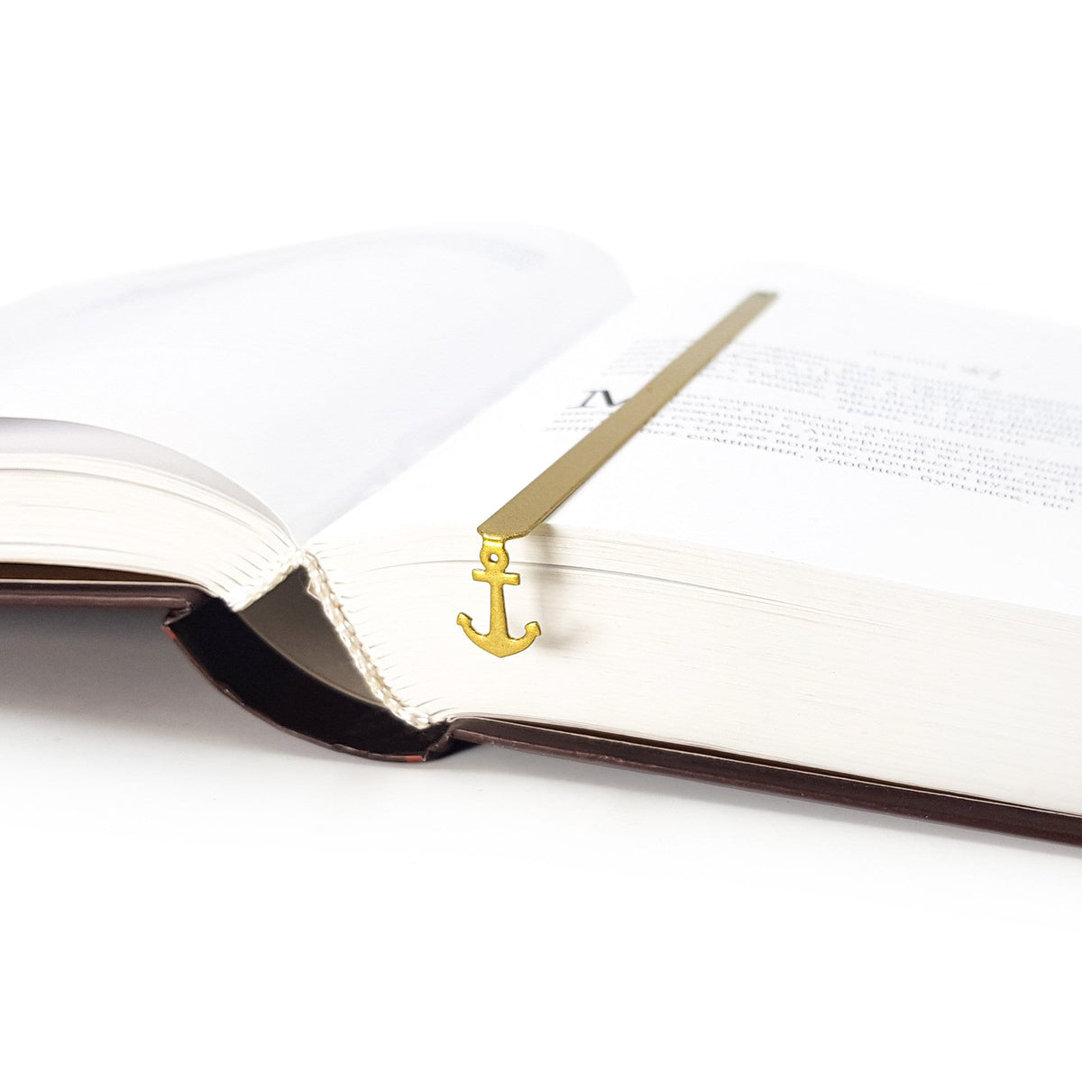 Anchor metal bookmark in gold tucked into a notebook
