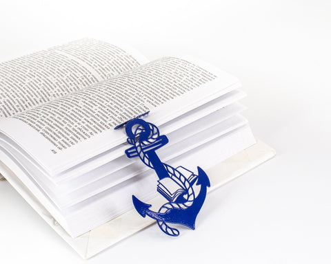 Anchor and the Books metal bookmark in blue resting on the pages of an open book