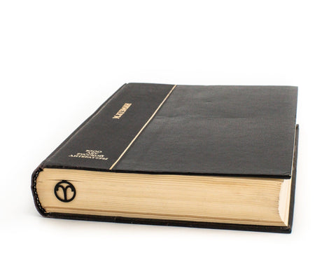 Aries metal bookmark in a closed book, only its top showing above the pages