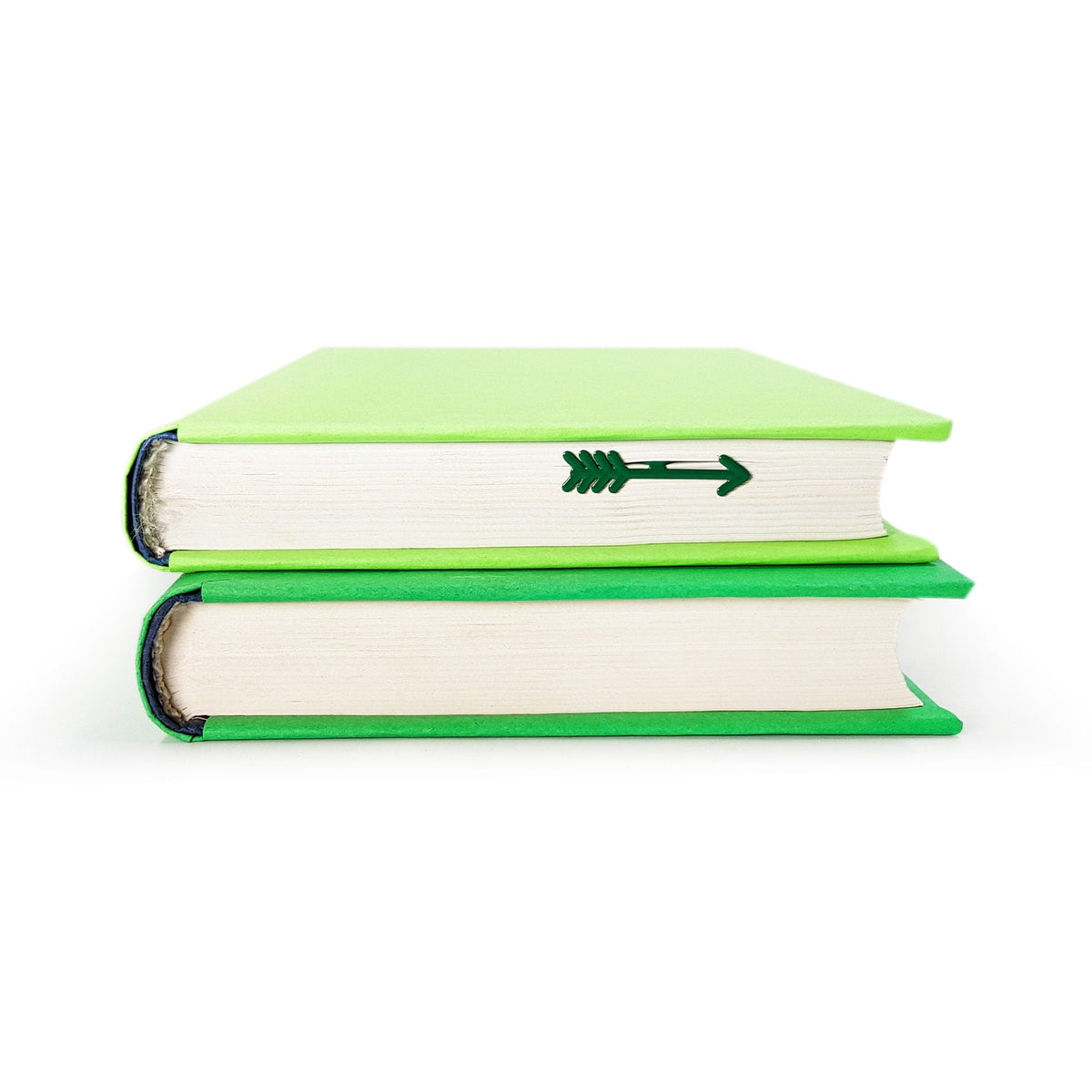 Arrow metal bookmark shown with a stack of books