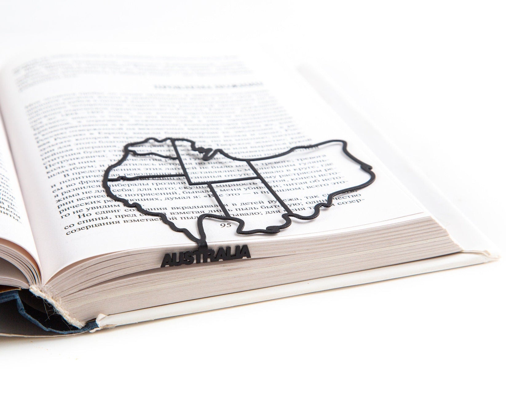 Australia metal bookmark lying across the pages of an open book