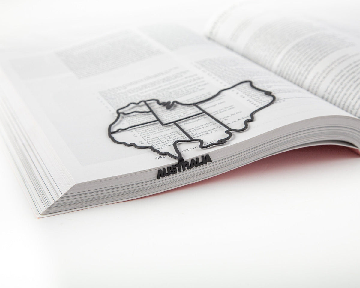 Australia metal bookmark marking a page in an open book