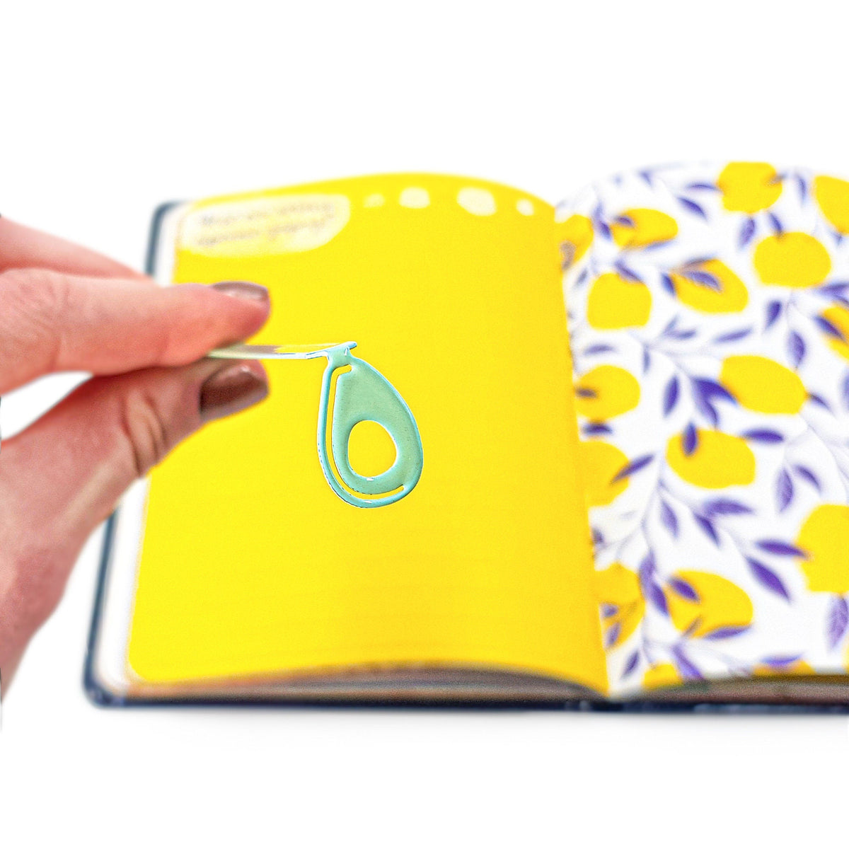 Avocado metal bookmark on a coloured background