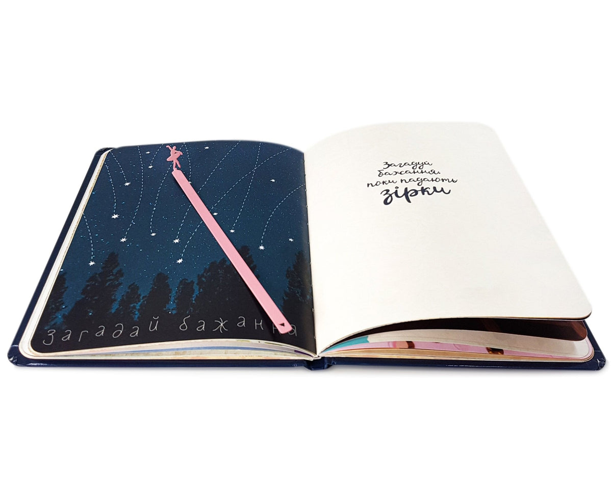 Ballet Dancer metal bookmark in red marking a page in an open book