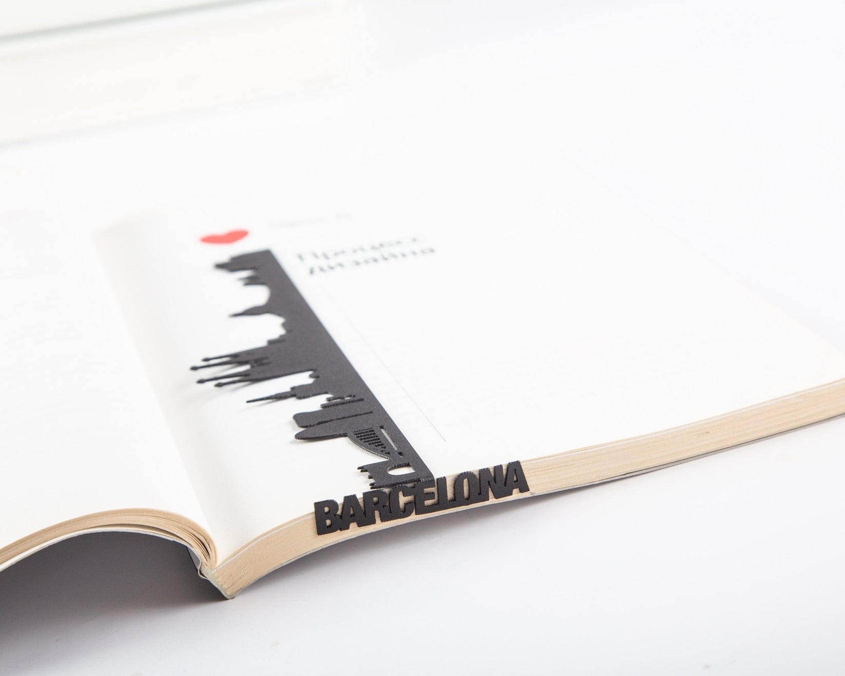 Barcelona Cityscape metal bookmark marking a page in a notebook