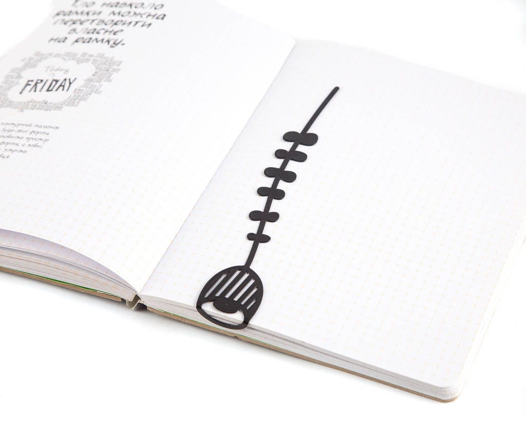 Bellflower metal bookmark resting on the pages of an open book