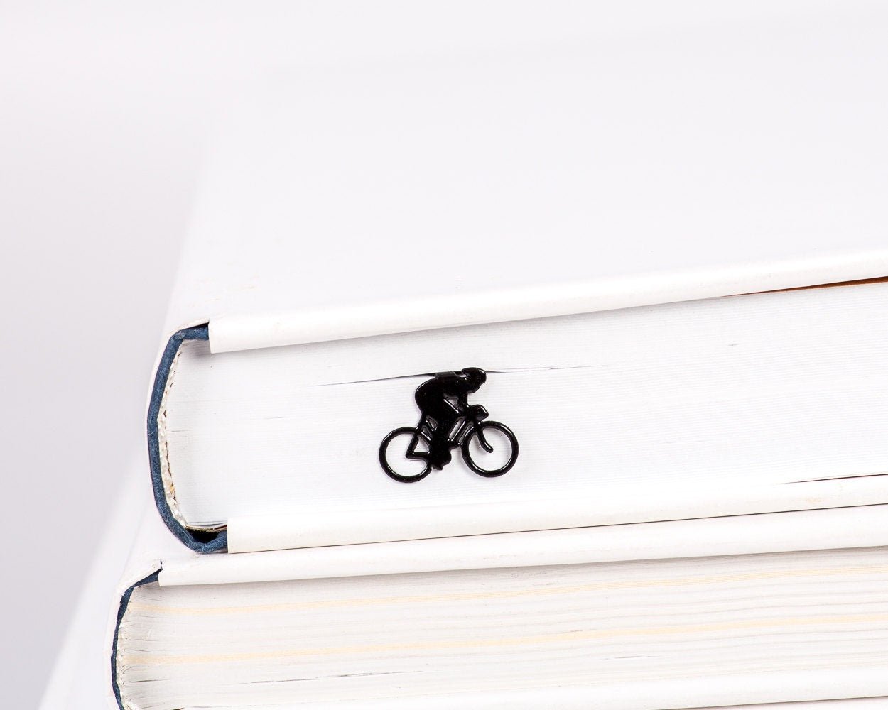 Bike Racing metal bookmark in a closed book, only its top showing above the pages