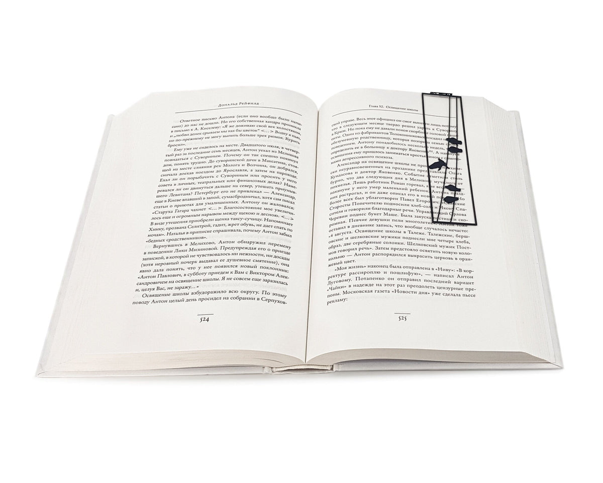 Birds on the Wire metal bookmark resting on the pages of an open book