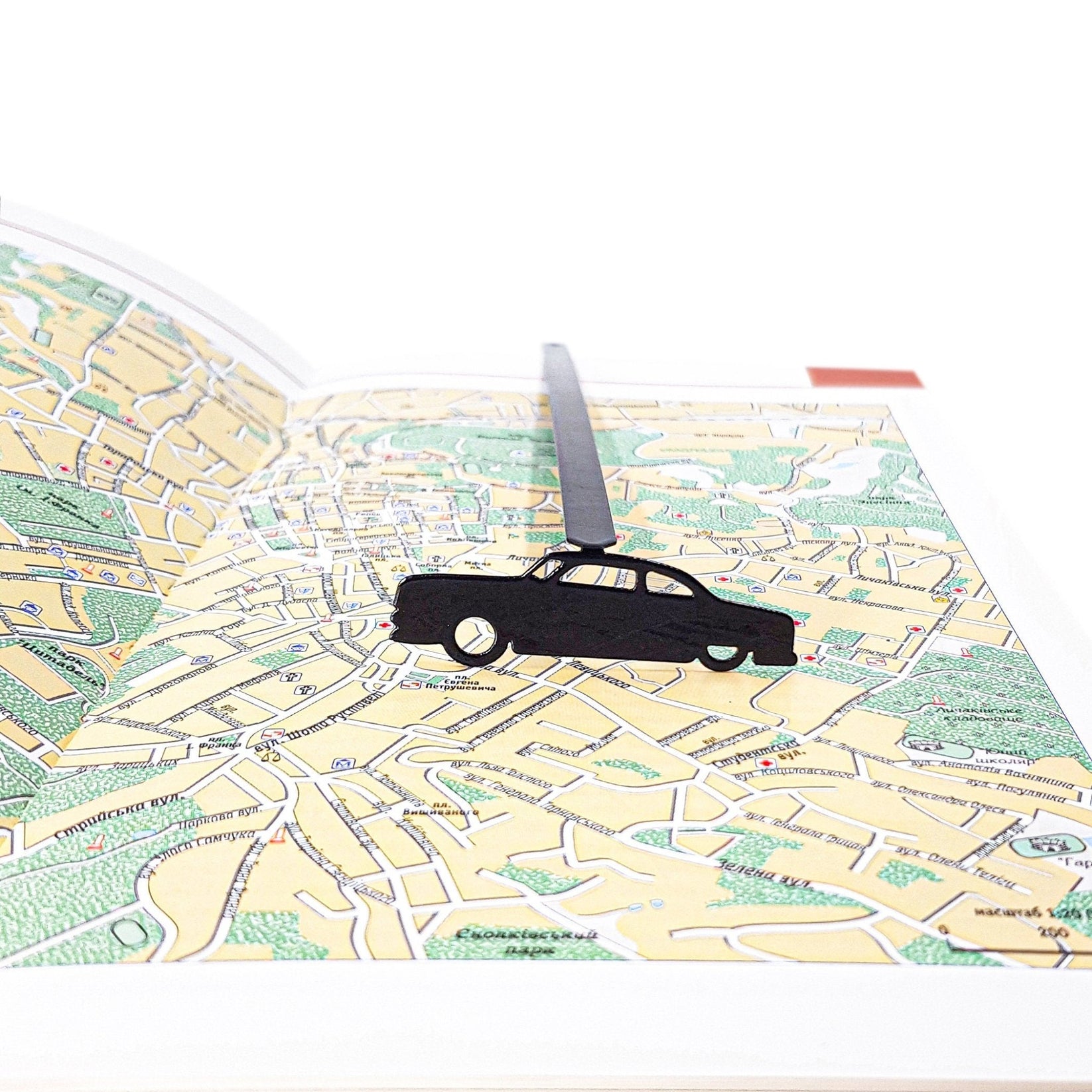 Black Car Phantom metal bookmark against a coloured backdrop