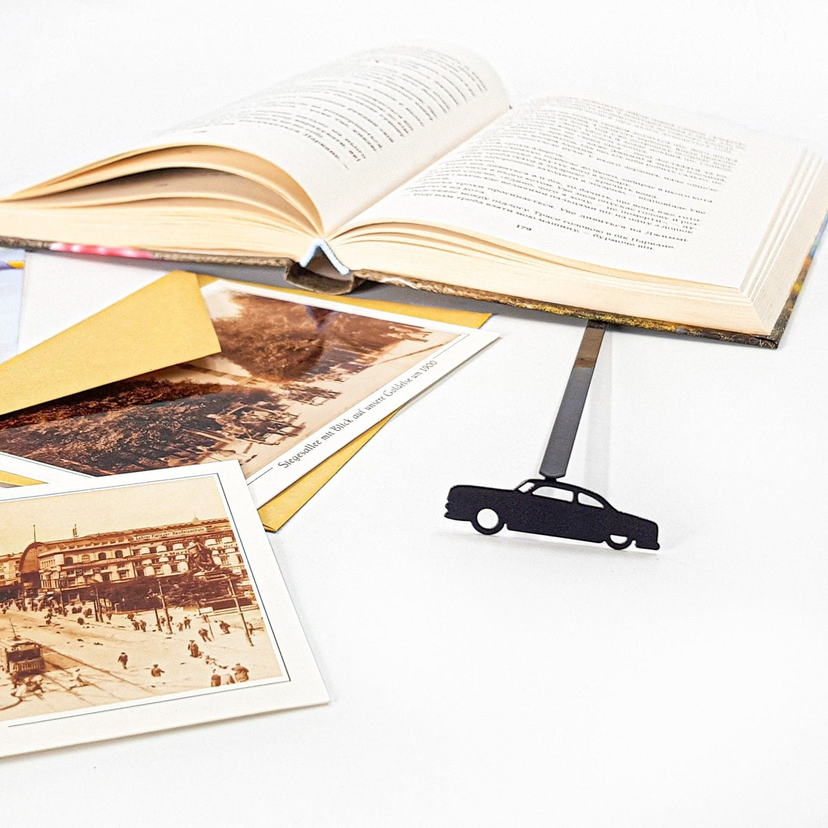 Black Car Phantom metal bookmark on an illustrated page
