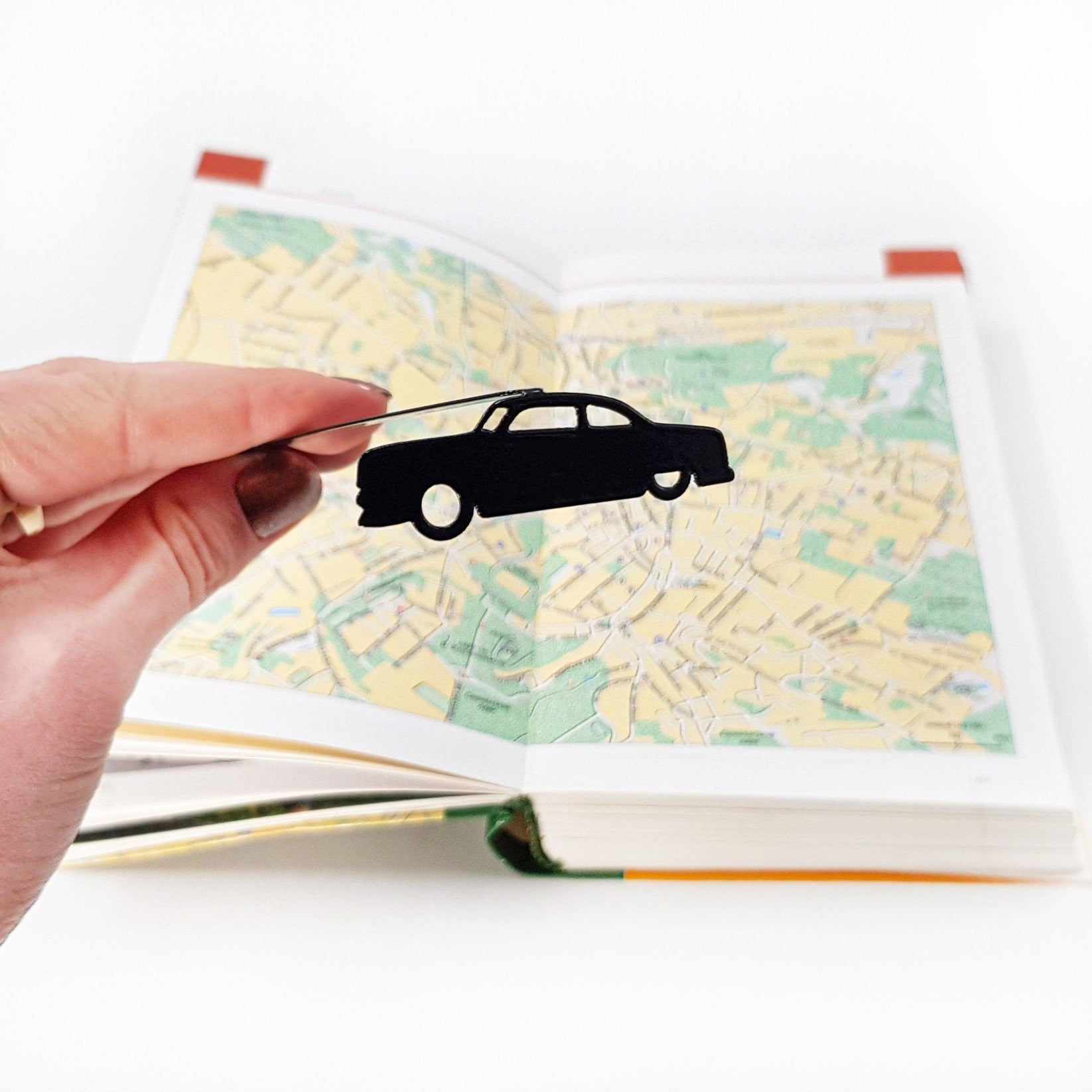 Black Car Phantom metal bookmark on a coloured background