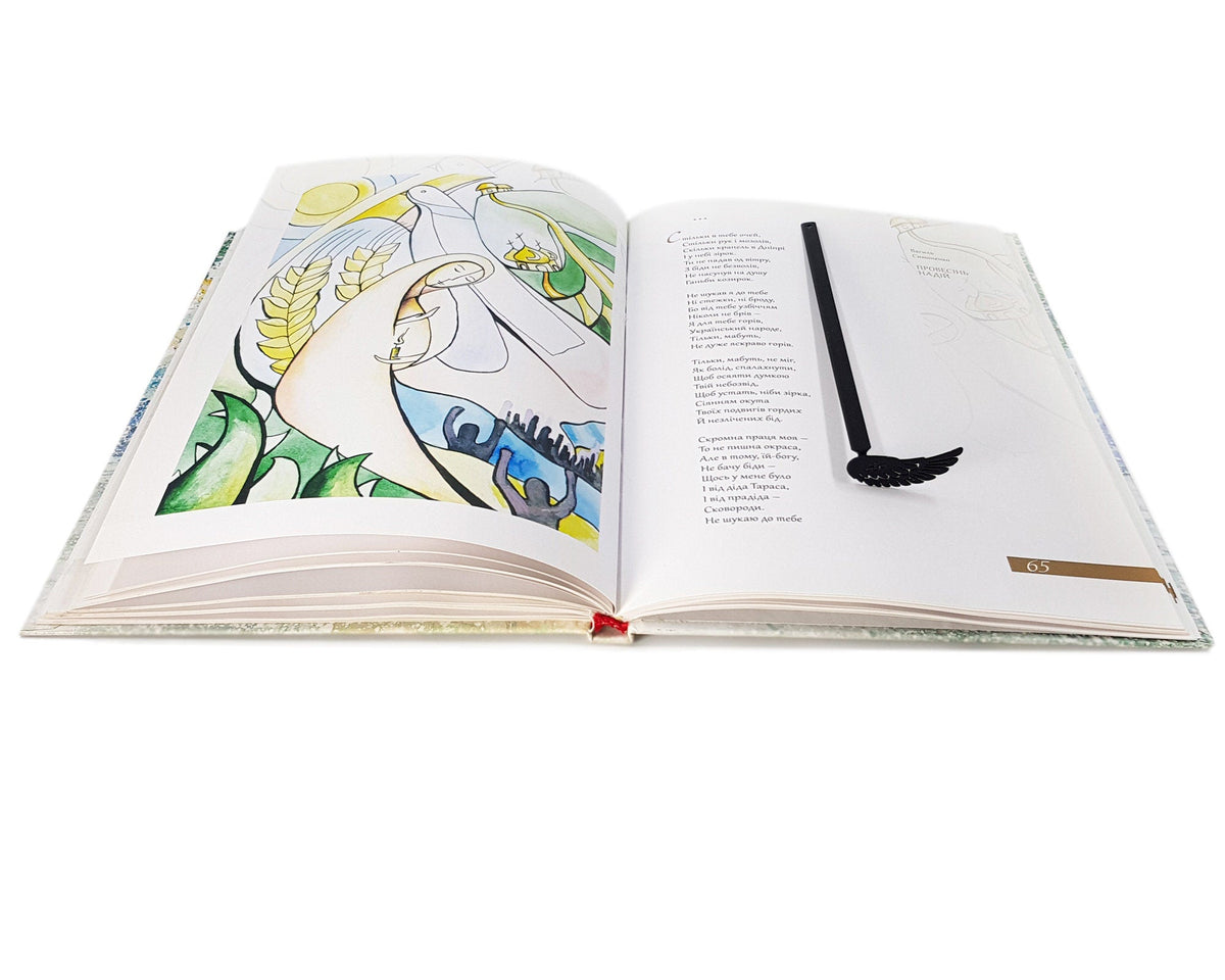 Black Wing metal bookmark on an illustrated page