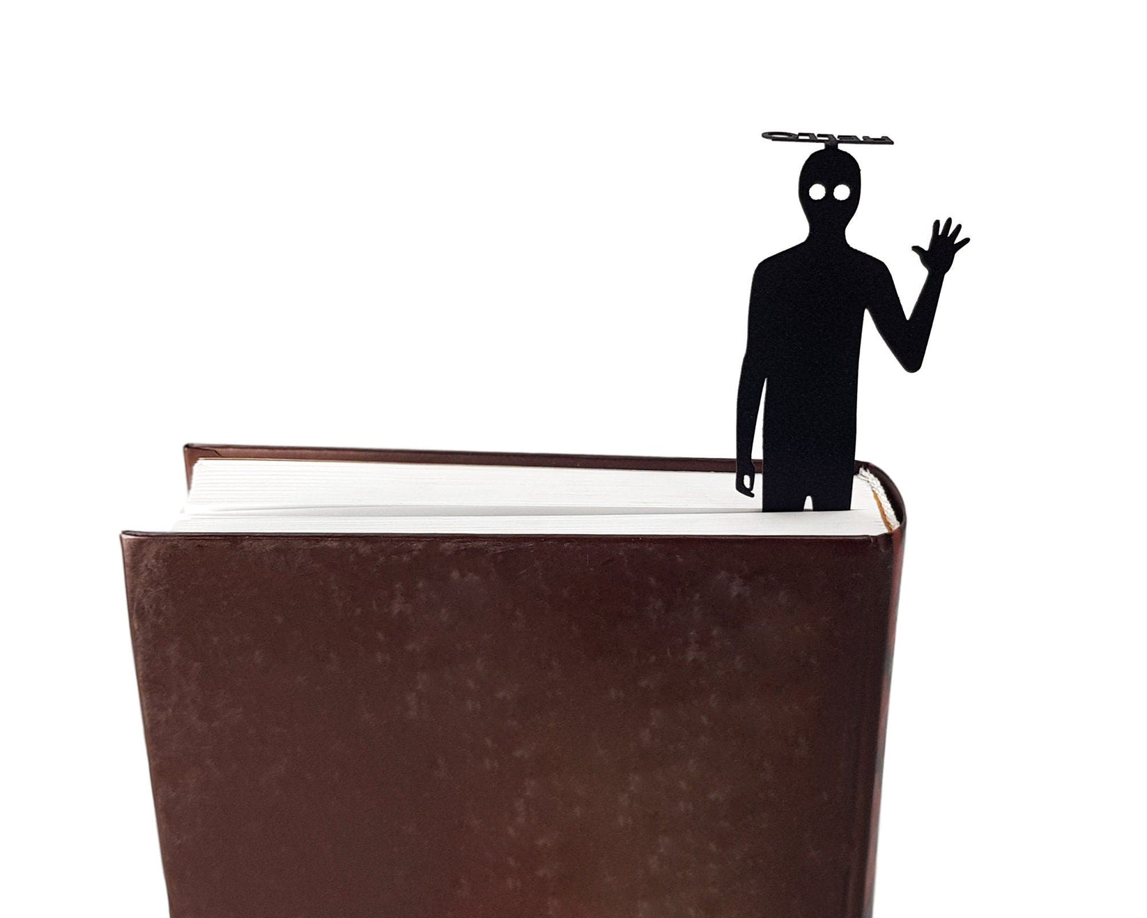 Book Ghost metal bookmark seen from the edge of a closed book
