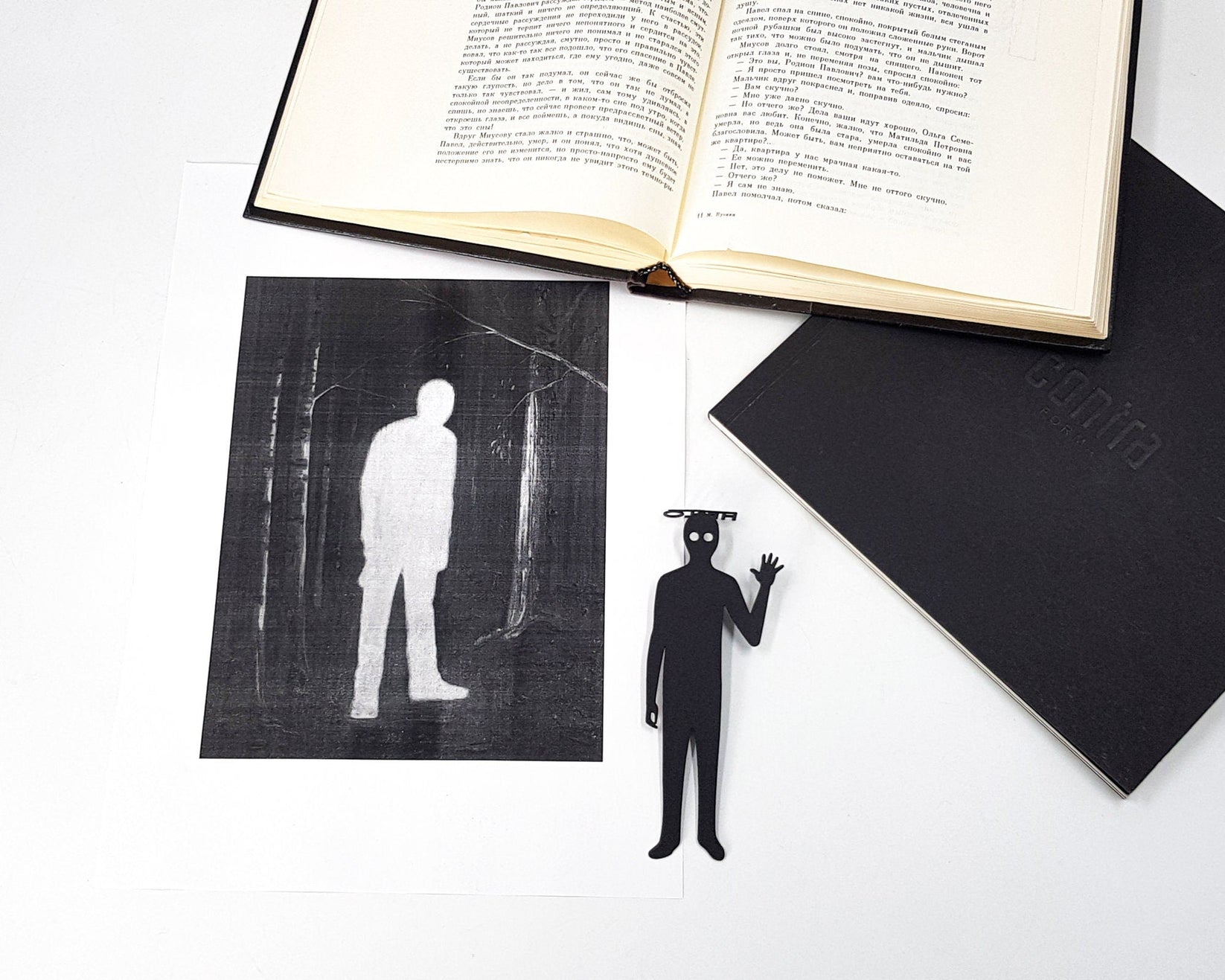 Book Ghost metal bookmark resting on the pages of an open book, view 5