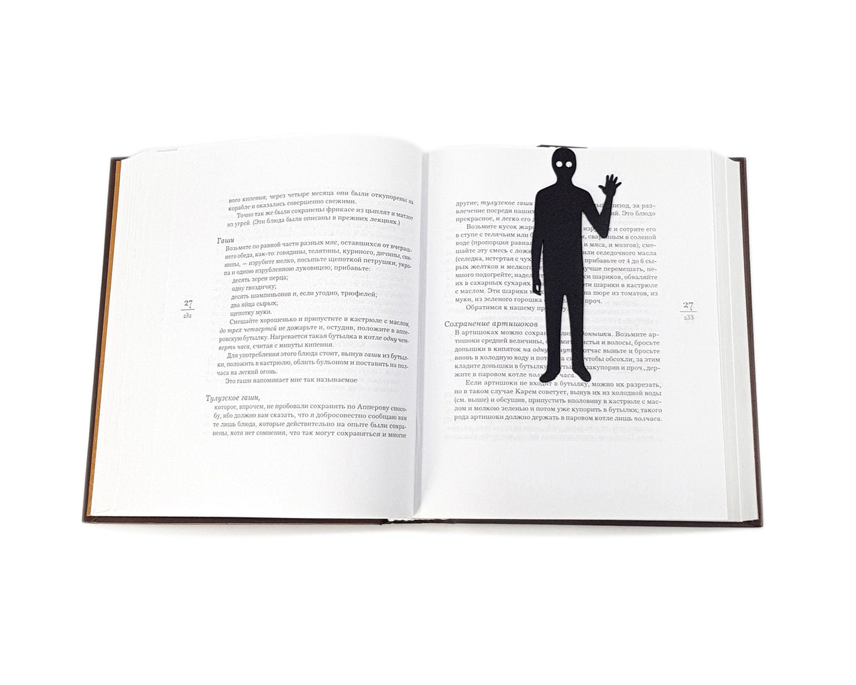 Book Ghost metal bookmark marking a page in an open book