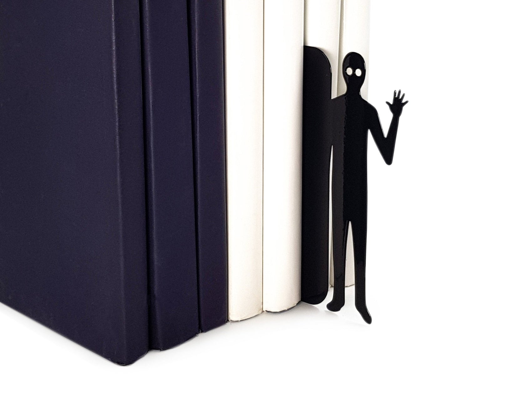 Book Ghost Coming Out metal bookmark marking a place in a closed book