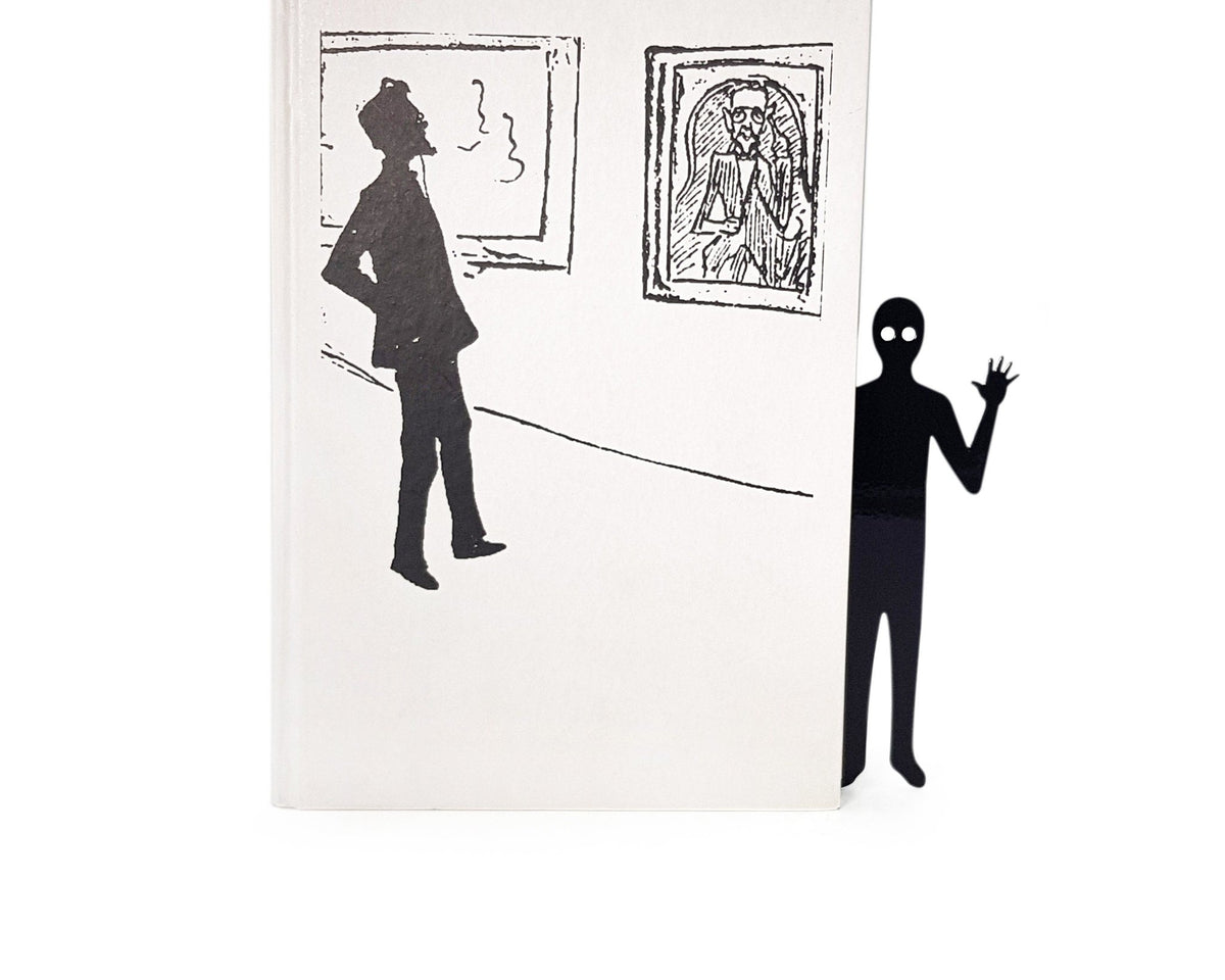 Book Ghost Coming Out metal bookmark marking a page in an illustrated book