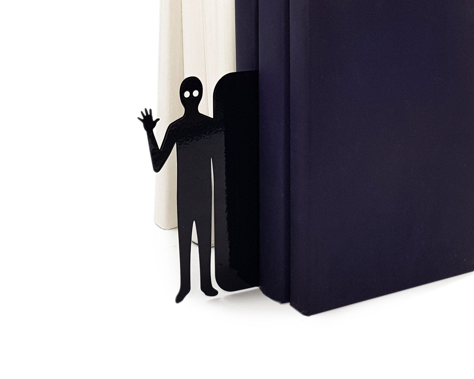 Book Ghost Coming Out metal bookmark in a closed book, only its top showing above the pages, view 5