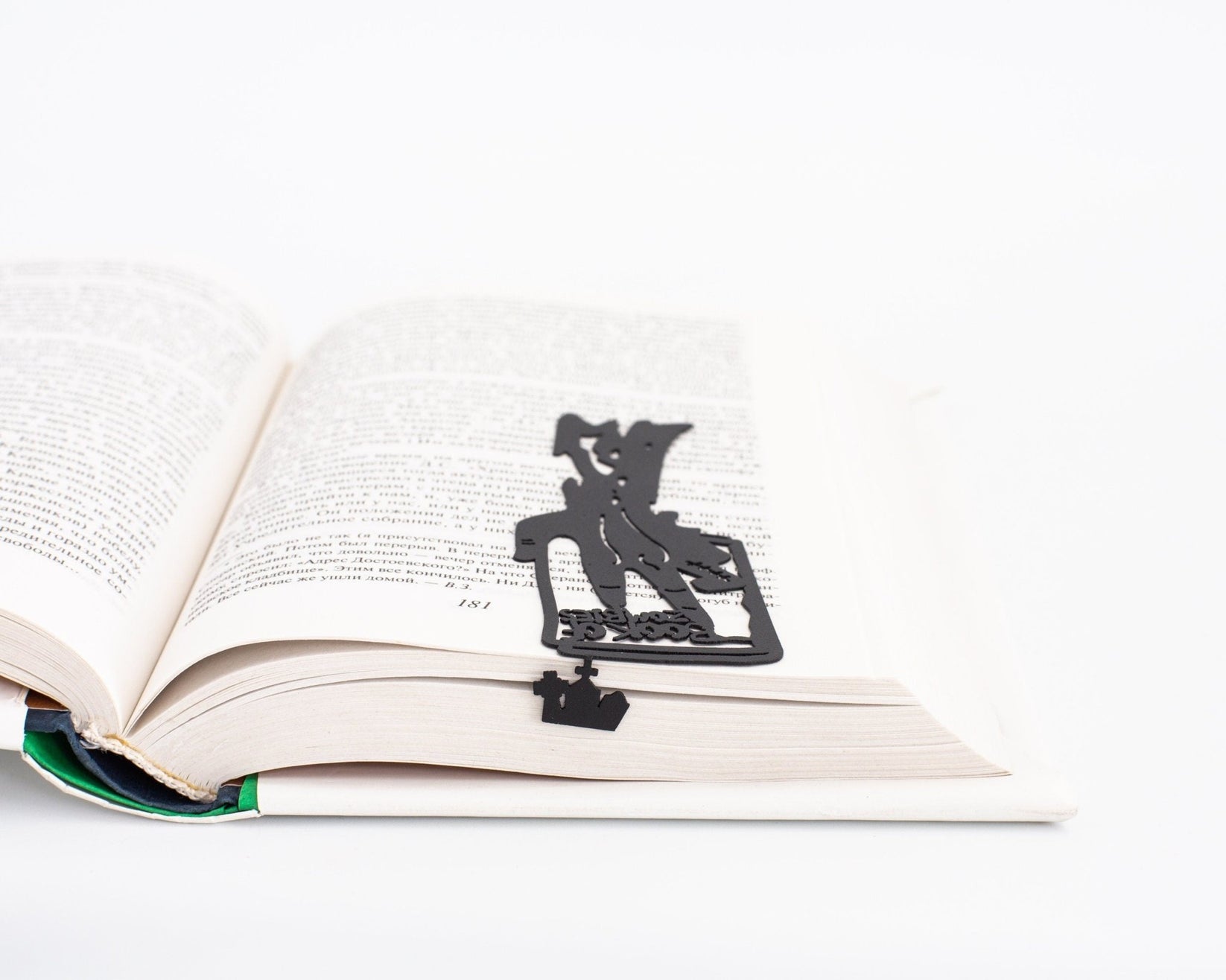 Book of Zombies metal bookmark marking a page in an open book