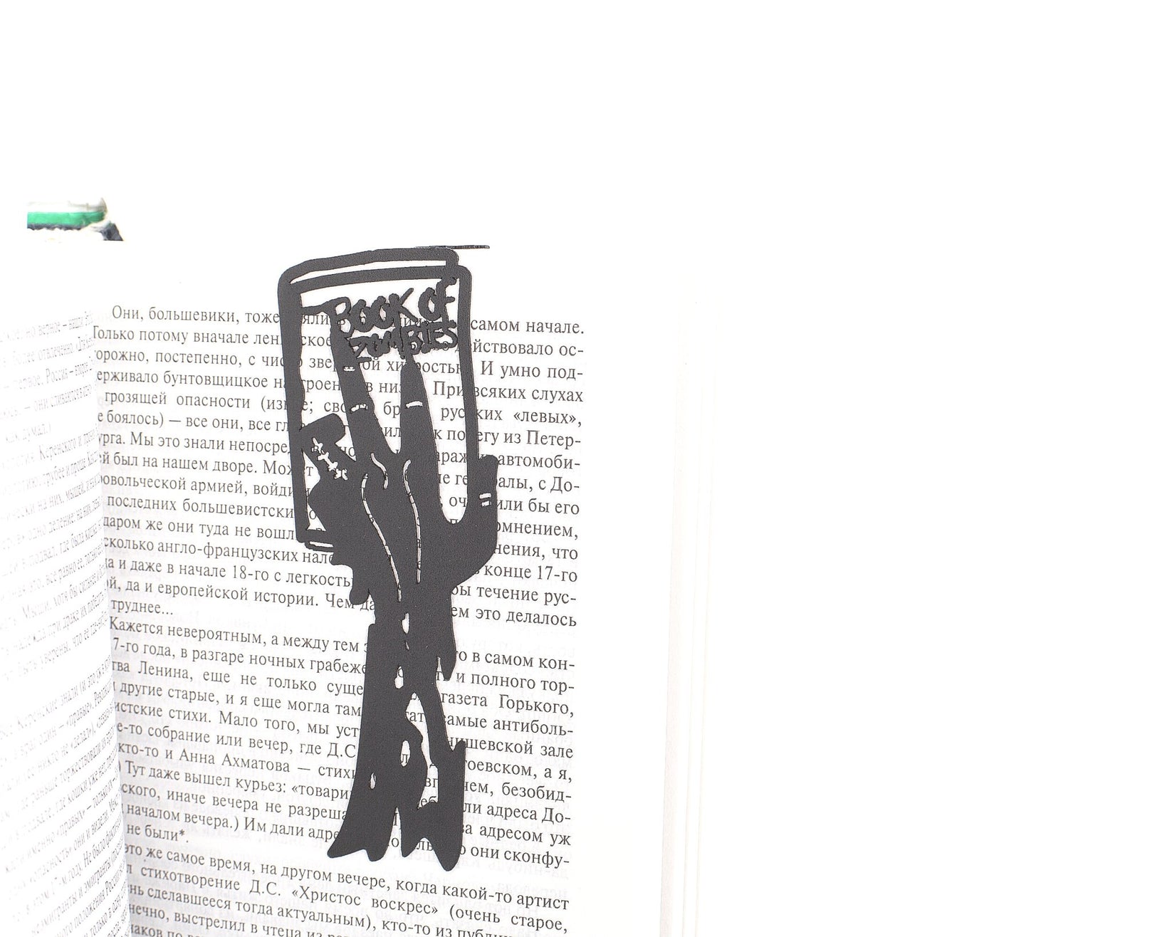 Book of Zombies metal bookmark resting on the pages of an open book