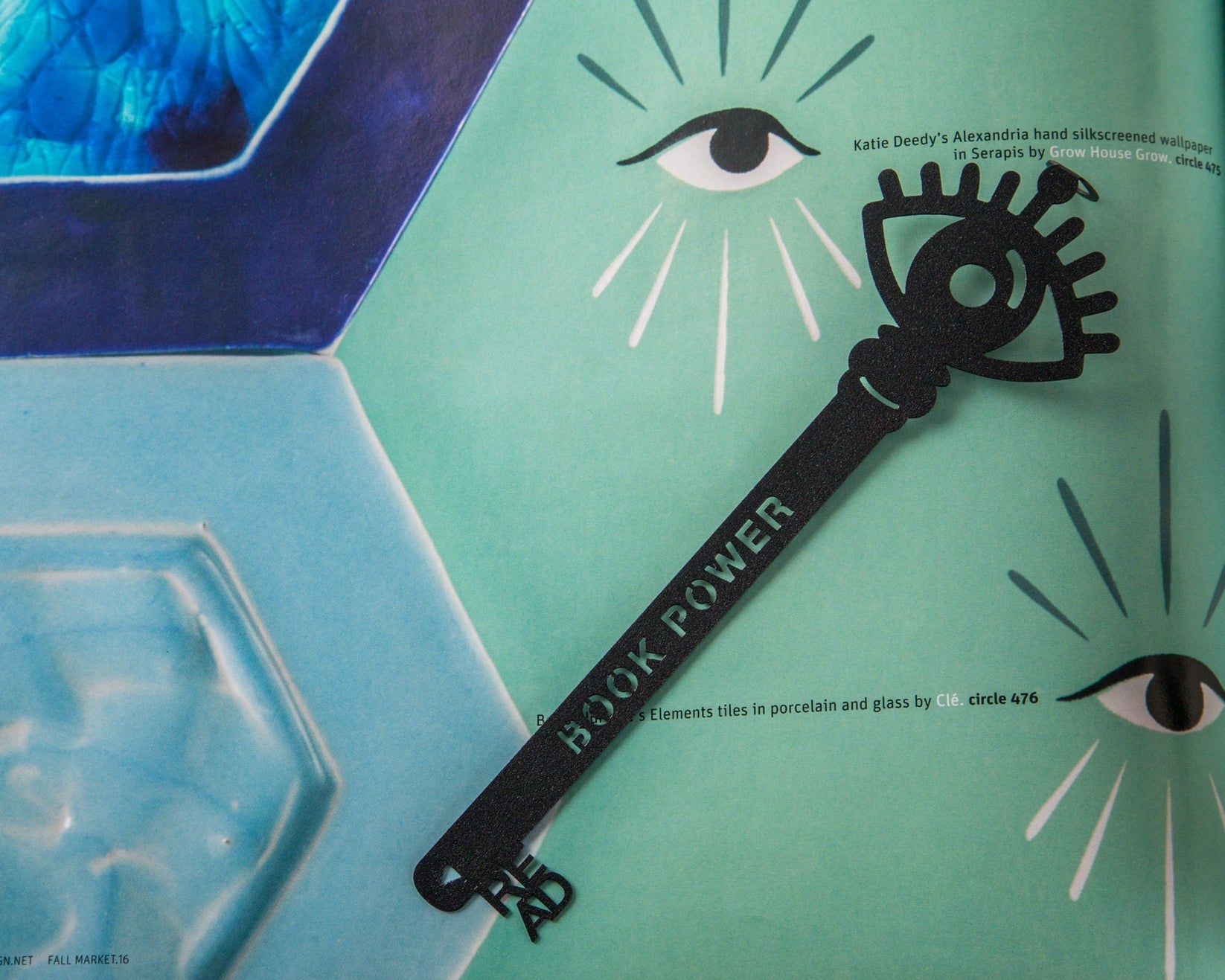 Book Power Is the Key metal bookmark placed on a colour illustration