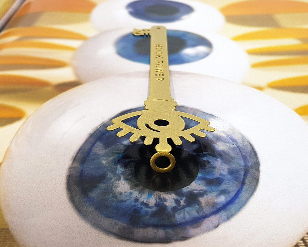 Book Power Is the Key metal bookmark in gold marking a page in an illustrated book, view 4