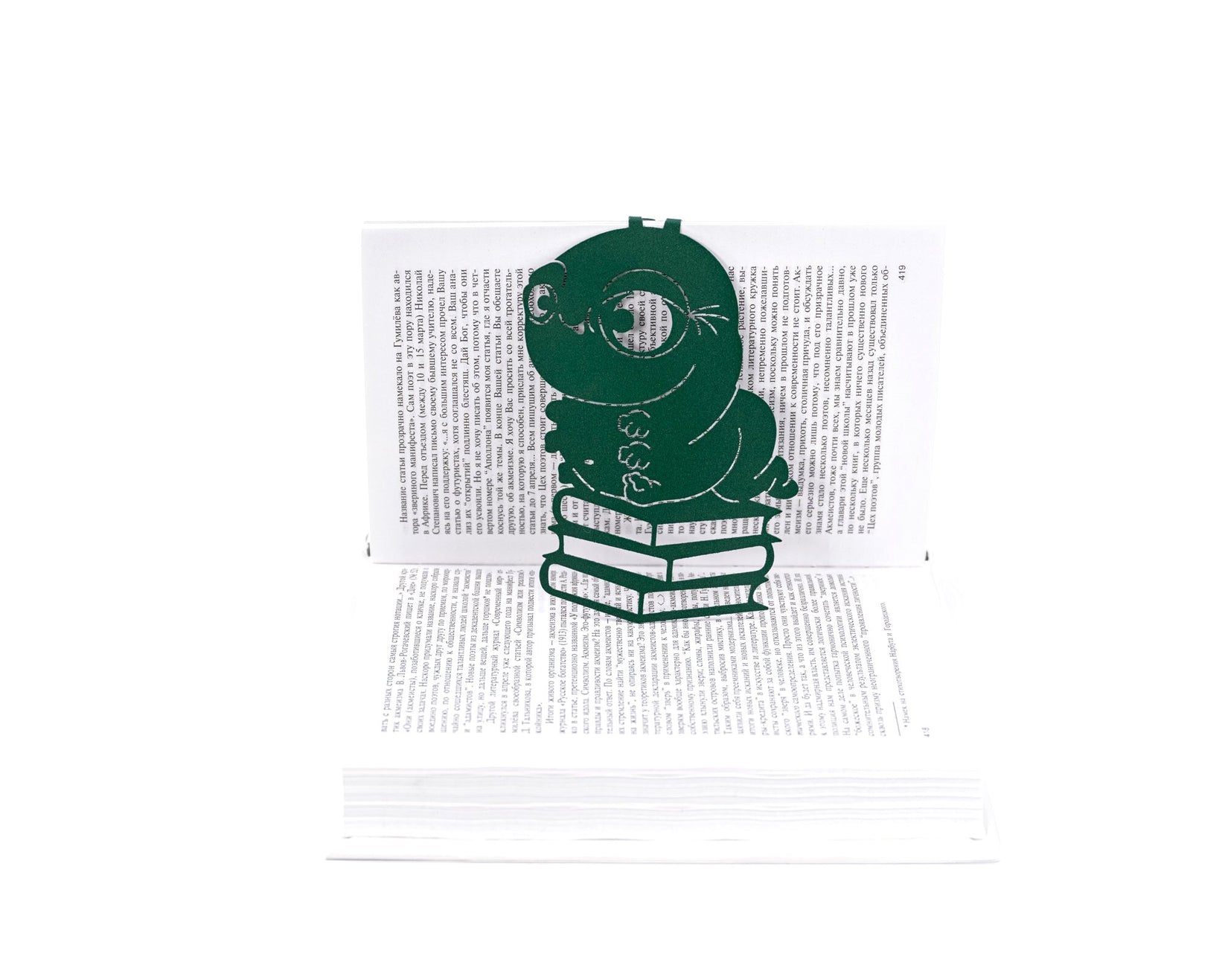 Bookworm metal bookmark in green marking a page in an open book