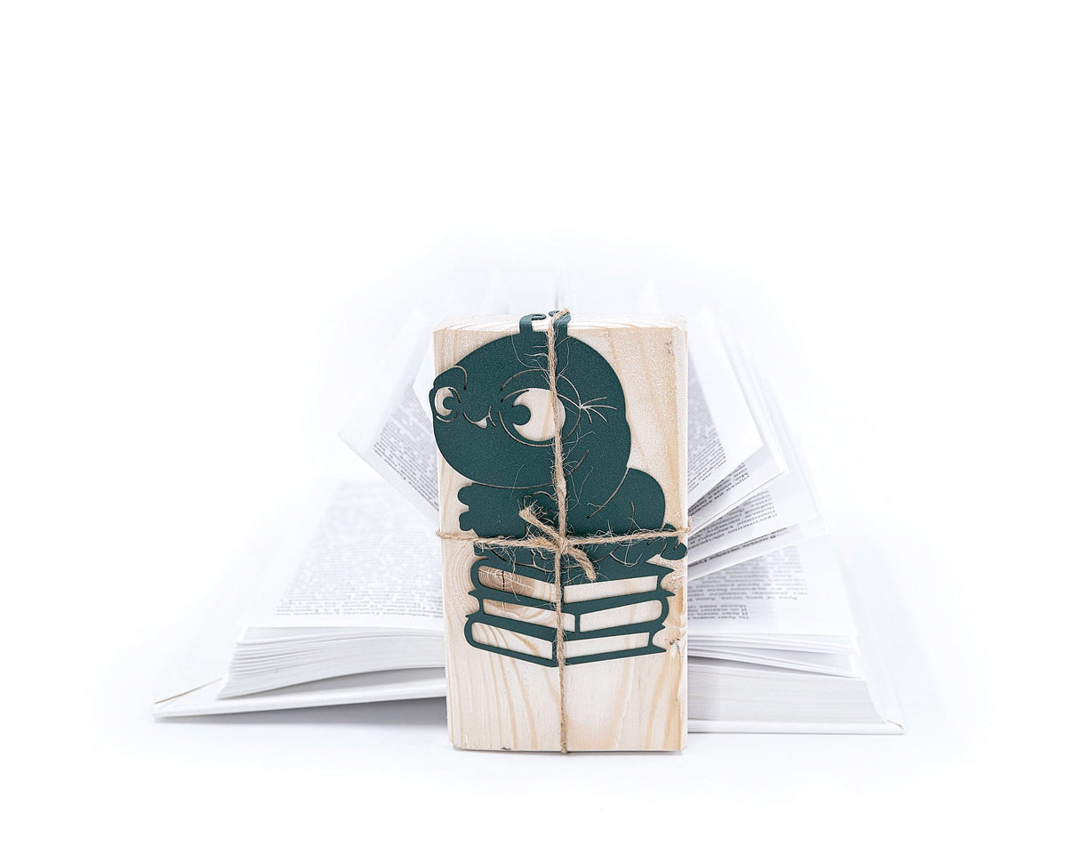 Bookworm metal bookmark in green set into the gutter of an open book