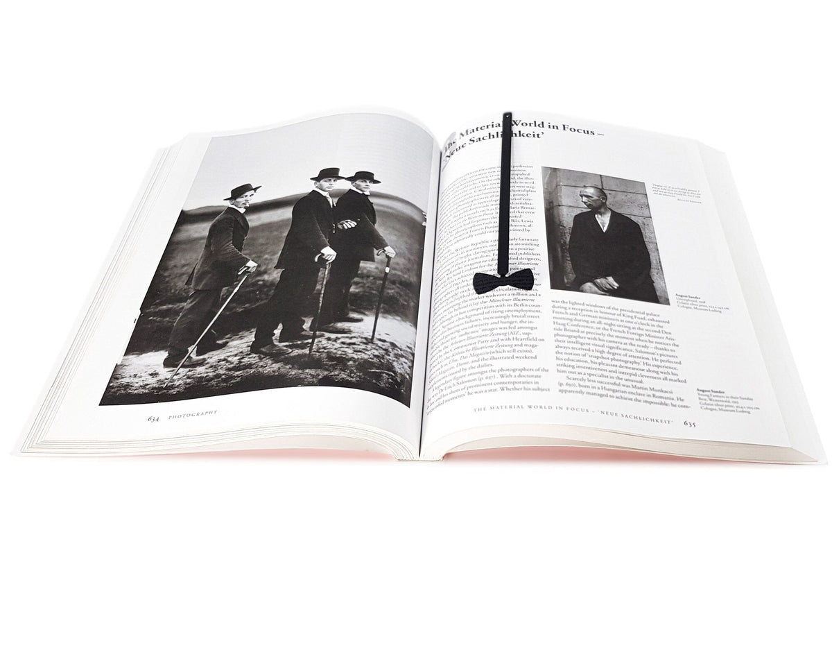 Bow Tie metal bookmark on an illustrated page
