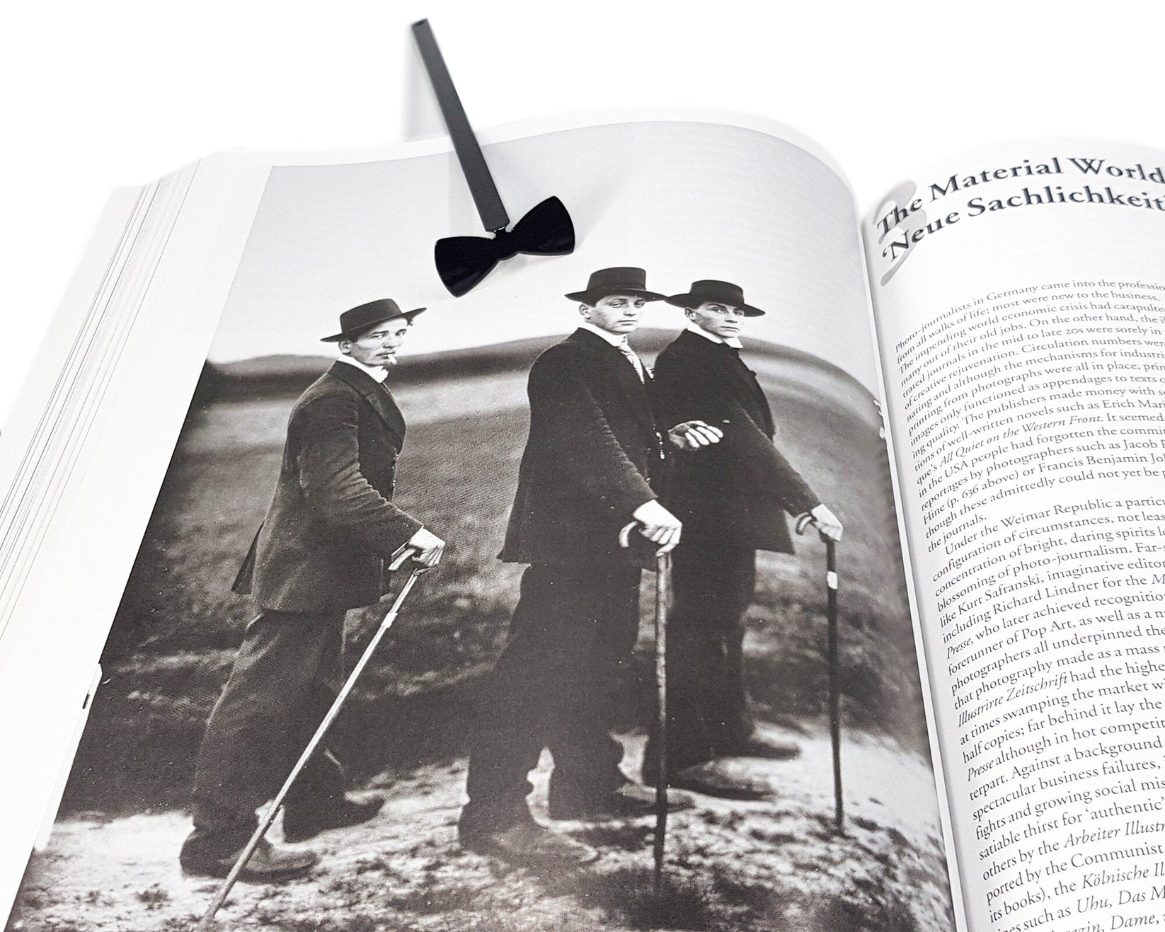 Bow Tie metal bookmark marking a page in an illustrated book