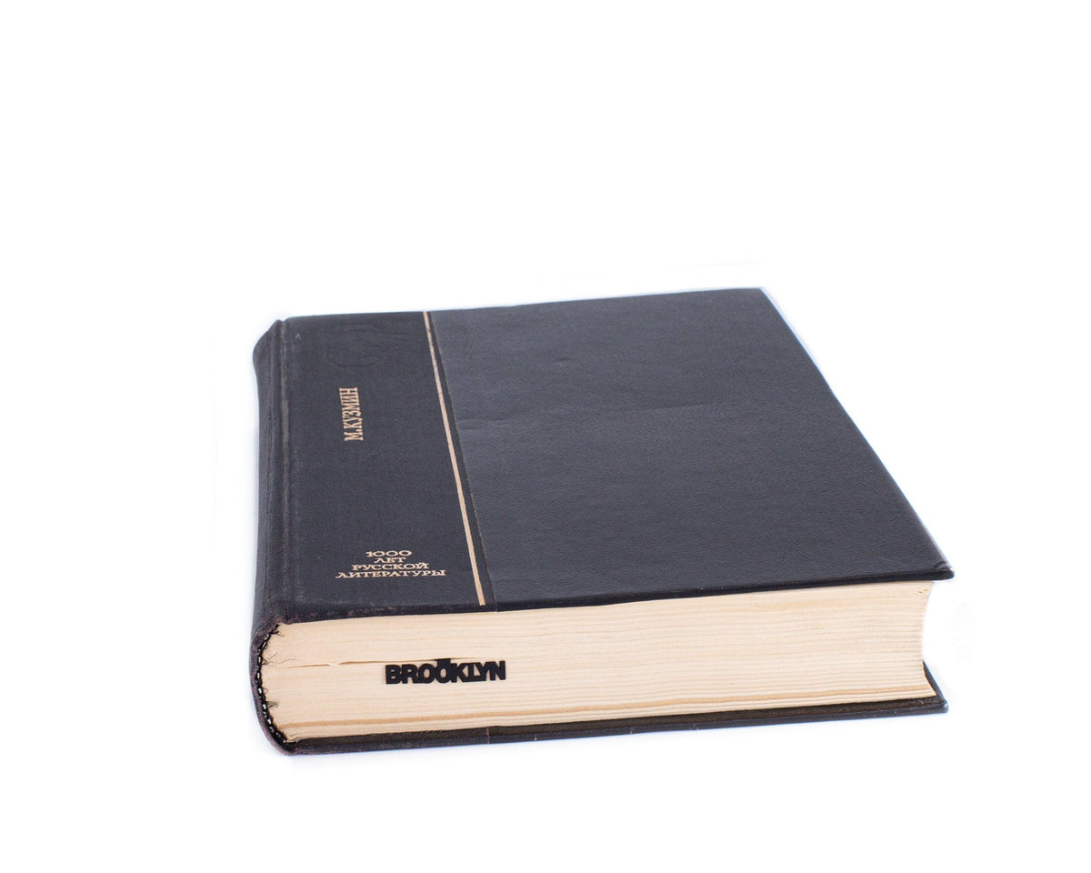 Brooklyn Bridge metal bookmark seen from the edge of a closed book