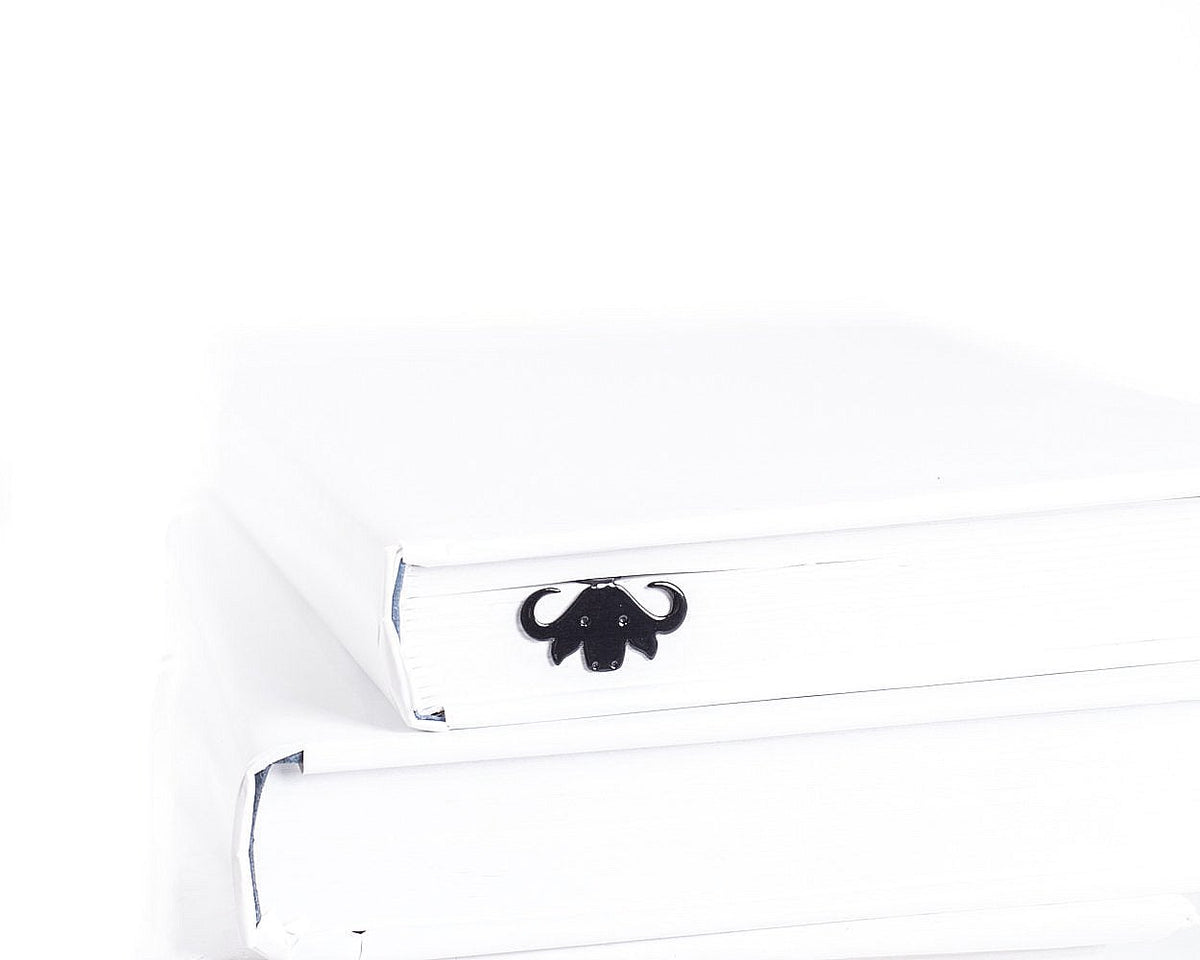 Buffalo metal bookmark in a closed book, only its top showing above the pages