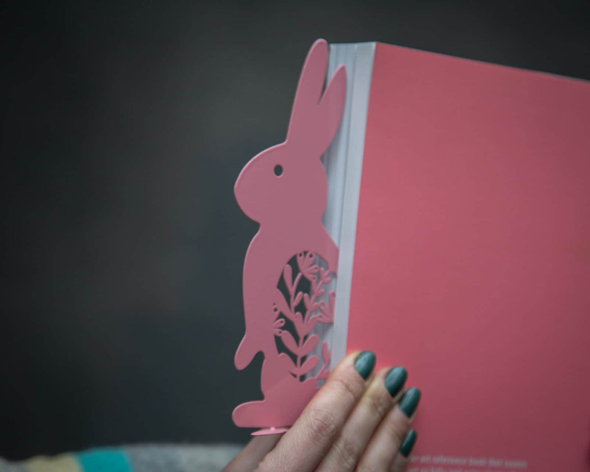 Bunny with a Carrot metal bookmark in red against a coloured backdrop