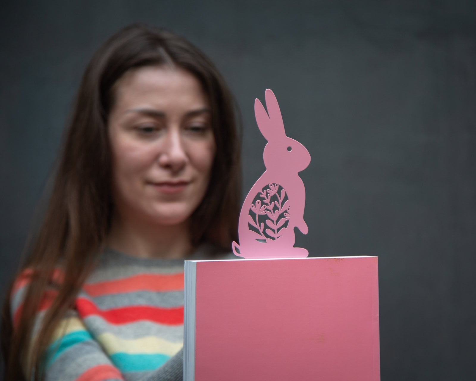Bunny with a Carrot metal bookmark — woman holding pink card with bookmark
